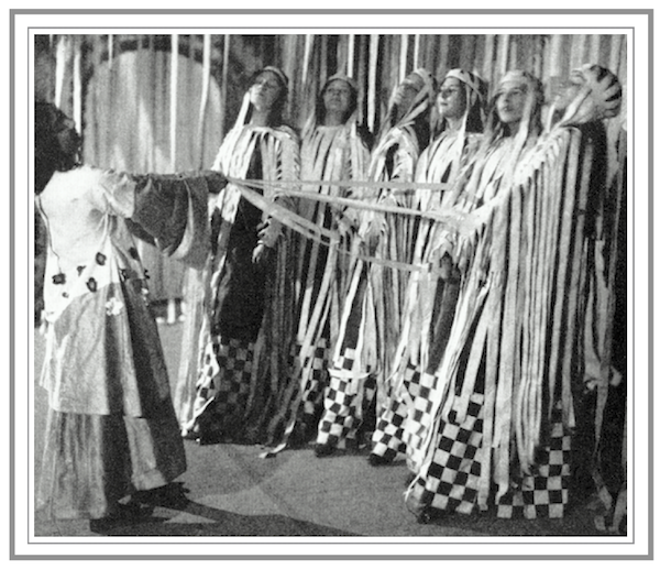 Craigs designs for the chorus of the Purcell Operatic Society; group of young women in long robes with white strips of fabric flowing from their arms