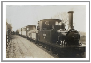 A narrow gauge railway train  arrives at Southwold station